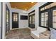 Cozy patio featuring stone flooring, a wall-mounted TV, and a comfortable chair with stylish cushions at 2316 Westminster Pl, Charlotte, NC 28207