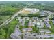 Community aerial view showcases tree lined roads, mature trees and greenery, and pool at 2388 Loch Stone Dr # E, Gastonia, NC 28054