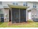 Home's cozy screened-in porch with fan, paired with exterior features like an AC unit and doors at 2388 Loch Stone Dr # E, Gastonia, NC 28054