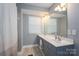 Bathroom featuring a double sink vanity with modern fixtures and wood look flooring at 2388 Loch Stone Dr # E, Gastonia, NC 28054