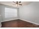 Bright bedroom with hardwood floors, ceiling fan, and large window at 2388 Loch Stone Dr # E, Gastonia, NC 28054