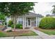 Charming clubhouse entrance with well-manicured landscaping, columns, and inviting walkway at 2388 Loch Stone Dr # E, Gastonia, NC 28054