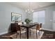 This dining room with hardwood floors, features modern chandelier and is staged with table and decor at 2388 Loch Stone Dr # E, Gastonia, NC 28054