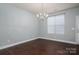Empty dining room features hardwood floors, modern lighting and neutral paint, ready for personalization at 2388 Loch Stone Dr # E, Gastonia, NC 28054