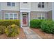 Charming front entrance with landscaped bushes and a red door at 2388 Loch Stone Dr # E, Gastonia, NC 28054