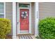 Inviting front door with decorative wreath and well-maintained landscaping at 2388 Loch Stone Dr # E, Gastonia, NC 28054