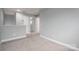 Hallway features neutral paint, carpeted flooring and multiple doors at 2388 Loch Stone Dr # E, Gastonia, NC 28054