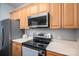 Close up of the stainless steel oven, microwave, countertops and light wood cabinetry in the kitchen at 2388 Loch Stone Dr # E, Gastonia, NC 28054