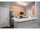 Bright kitchen offers a breakfast bar with seating, stainless steel appliances and light wood cabinetry at 2388 Loch Stone Dr # E, Gastonia, NC 28054