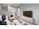 Living room staged with modern furniture, TV and neutral paint at 2388 Loch Stone Dr # E, Gastonia, NC 28054