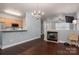 Open-concept living space features wood floors, a fireplace and seamlessly connects the kitchen and living area at 2388 Loch Stone Dr # E, Gastonia, NC 28054