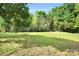 Expansive green lawn with mature trees and a serene, natural setting at 2417 Hamilton Mill Rd, Charlotte, NC 28270