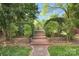 Scenic backyard with lush landscaping, brick pathway, and natural beauty at 2417 Hamilton Mill Rd, Charlotte, NC 28270