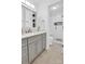This bathroom features a gray vanity with gray cabinetry and a glass-door shower at 2417 Hamilton Mill Rd, Charlotte, NC 28270
