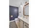 Bathroom with blue accent wall, neutral vanity, and geometric-patterned floor at 2417 Hamilton Mill Rd, Charlotte, NC 28270