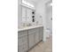 This bathroom features a gray vanity with gray cabinetry and a glass-door shower at 2417 Hamilton Mill Rd, Charlotte, NC 28270
