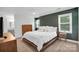 This bedroom features natural light, white ceilings and walls, and a leather frame bed at 2417 Hamilton Mill Rd, Charlotte, NC 28270