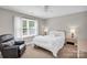 Comfortable bedroom with a queen bed, recliner and a ceiling fan at 2417 Hamilton Mill Rd, Charlotte, NC 28270