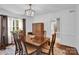 Elegant dining room featuring hardwood floors, a crystal chandelier, and abundant natural light at 2417 Hamilton Mill Rd, Charlotte, NC 28270