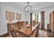 An elegant dining room with hardwood floors, stylish light fixture, and a window at 2417 Hamilton Mill Rd, Charlotte, NC 28270