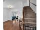 Grand foyer featuring hardwood floors, a staircase, and an open view into a living area at 2417 Hamilton Mill Rd, Charlotte, NC 28270