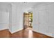 Welcoming entryway with hardwood floors, white trim, and a solid wood front door with glass panels at 2417 Hamilton Mill Rd, Charlotte, NC 28270