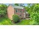 Brick home featuring a well-maintained lawn, neat landscaping, and inviting curb appeal at 2417 Hamilton Mill Rd, Charlotte, NC 28270