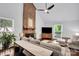 Bright living room featuring hardwood floors, neutral decor, fireplace, and vaulted ceiling at 2417 Hamilton Mill Rd, Charlotte, NC 28270