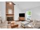 Bright living room with a brick fireplace, hardwood floors, and comfortable seating at 2417 Hamilton Mill Rd, Charlotte, NC 28270