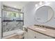 Renovated bathroom with a shower, new vanity, round mirror, and granite counters at 2515 Danforth Ln, Charlotte, NC 28208