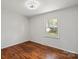 Bright bedroom with hardwood floors, a window and neutral colored walls at 2515 Danforth Ln, Charlotte, NC 28208