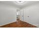 Bedroom with hardwood floors, a closet and a glimpse into another room at 2515 Danforth Ln, Charlotte, NC 28208