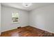 Bedroom with hardwood floors, a window and neutral colored walls at 2515 Danforth Ln, Charlotte, NC 28208
