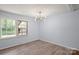 Cozy bedroom featuring luxury vinyl floors, neutral paint, natural light and a modern light fixture at 2515 Danforth Ln, Charlotte, NC 28208
