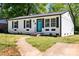 View of a charming home featuring a newly painted exterior, black shutters, and a vibrant turquoise front door at 2515 Danforth Ln, Charlotte, NC 28208