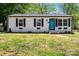 Charming home featuring a newly painted exterior, black shutters, and a vibrant turquoise front door at 2515 Danforth Ln, Charlotte, NC 28208