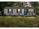 Charming home featuring a newly painted exterior, black shutters, and a vibrant turquoise front door at 2515 Danforth Ln, Charlotte, NC 28208