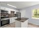 Modern kitchen features stainless steel appliances, tile backsplash and an island with a granite top at 2515 Danforth Ln, Charlotte, NC 28208