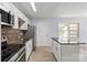 Well-lit kitchen features stainless steel appliances, tile backsplash and an island with granite top at 2515 Danforth Ln, Charlotte, NC 28208