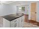 Bright kitchen features a center island with black countertop and modern white cabinets at 2515 Danforth Ln, Charlotte, NC 28208