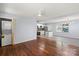 Open-concept living space with hardwood flooring and an adjacent updated kitchen area at 2515 Danforth Ln, Charlotte, NC 28208