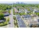 An aerial view of the property and surrounding neighborhood with Charlotte skyline visible in the distance at 2551 Statesville Ave, Charlotte, NC 28206