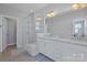 Bright bathroom featuring a glass shower, dual sink vanity with stone countertops, and modern fixtures at 2551 Statesville Ave, Charlotte, NC 28206