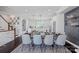 Open dining room with a large wooden table, stylish chairs, and kitchen in the background at 2551 Statesville Ave, Charlotte, NC 28206
