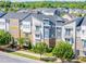Attractive exterior of townhomes with colorful design elements, small balconies and professionally maintained landscaping at 2551 Statesville Ave, Charlotte, NC 28206