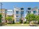 View of colorful townhomes featuring a sidewalk and professionally landscaped front yards at 2551 Statesville Ave, Charlotte, NC 28206