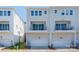 Exterior shot of modern townhomes featuring attached garages and small, private balconies at 2551 Statesville Ave, Charlotte, NC 28206