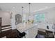 Bright kitchen featuring a granite island, stainless appliances, white cabinetry, and modern pendant lighting at 2551 Statesville Ave, Charlotte, NC 28206