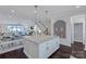 Spacious kitchen island with granite countertop, stylish pendant lights, and seating, adjacent to the dining area at 2551 Statesville Ave, Charlotte, NC 28206
