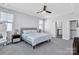 Neutral bedroom featuring a ceiling fan, large windows, and doorway access to a closet at 2551 Statesville Ave, Charlotte, NC 28206